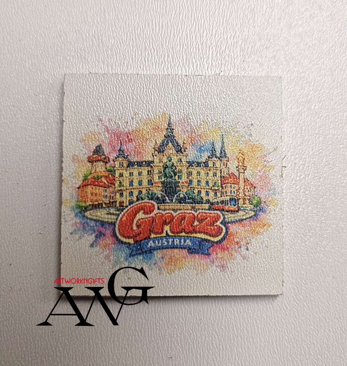 Watercolor artwork of the Graz city landscape in Austria.  Handmade wooden fridge magnet 5×5 cm